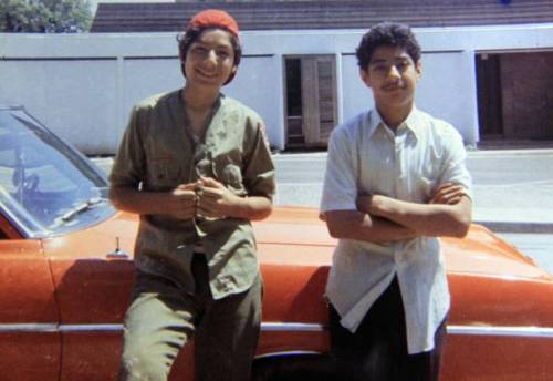 Santos Rodriguez, right, stands with his brother David next to a relative’s car just a month before Santos’ death.