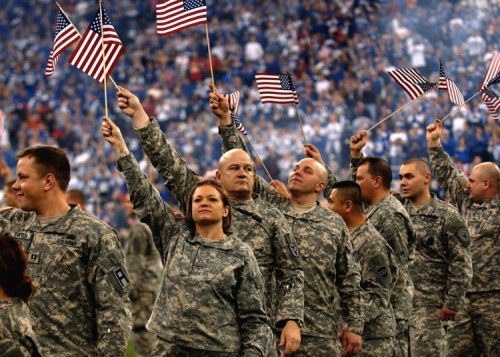 Soldiers wave American flags at the RCA Dome in Indianapolis.  Photo courtesy Staff Sgt. Russell Lee Klika, U.S. Army.
