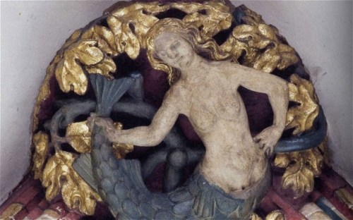 A mermaid on the roof of Exeter Cathedral in Exeter, England, c. 1400.