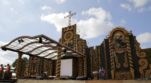 Workers put the finishing touches to an altar, made of corn and pumpkins, where Pope Francis will give the main mass on July 12 during his visit to Paraguay, in Asuncion