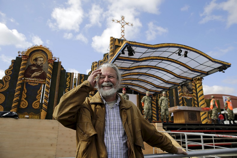 Paraguayan artist Koki Ruiz poses for a picture in front of an altar he built using corn and pumpkins, where Pope Francis will give the main mass on July 12.